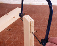 Using a coping saw to cut out waste