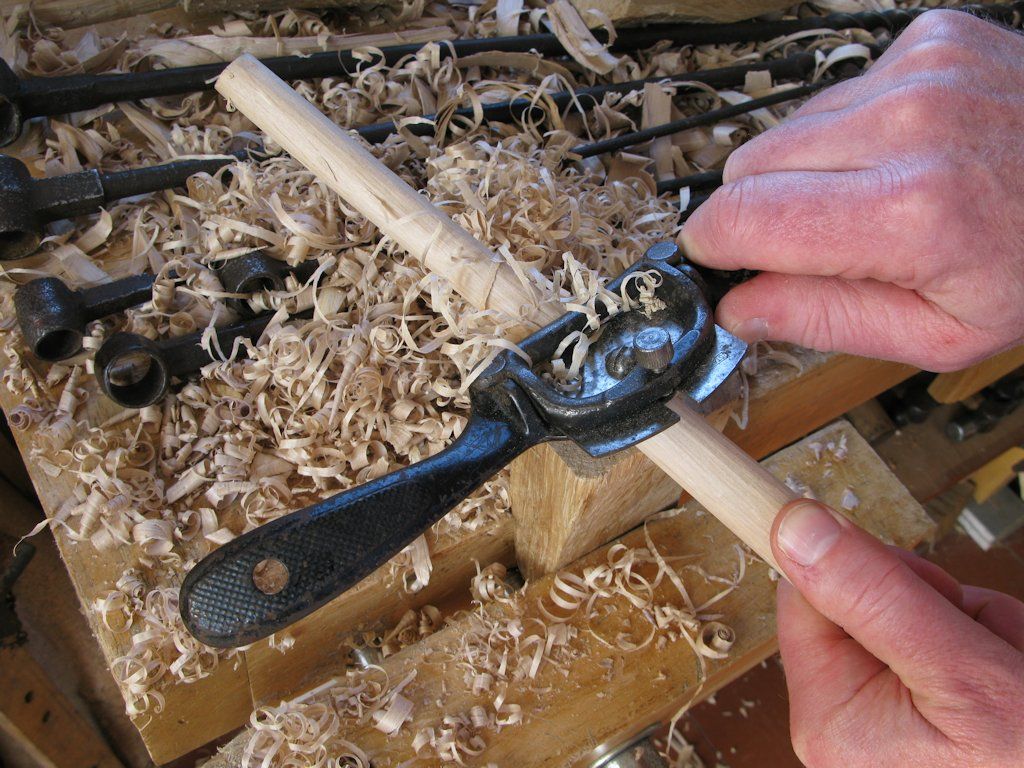 Robin Gates shaping a handle for a set of Scotch augers using the spokeshave