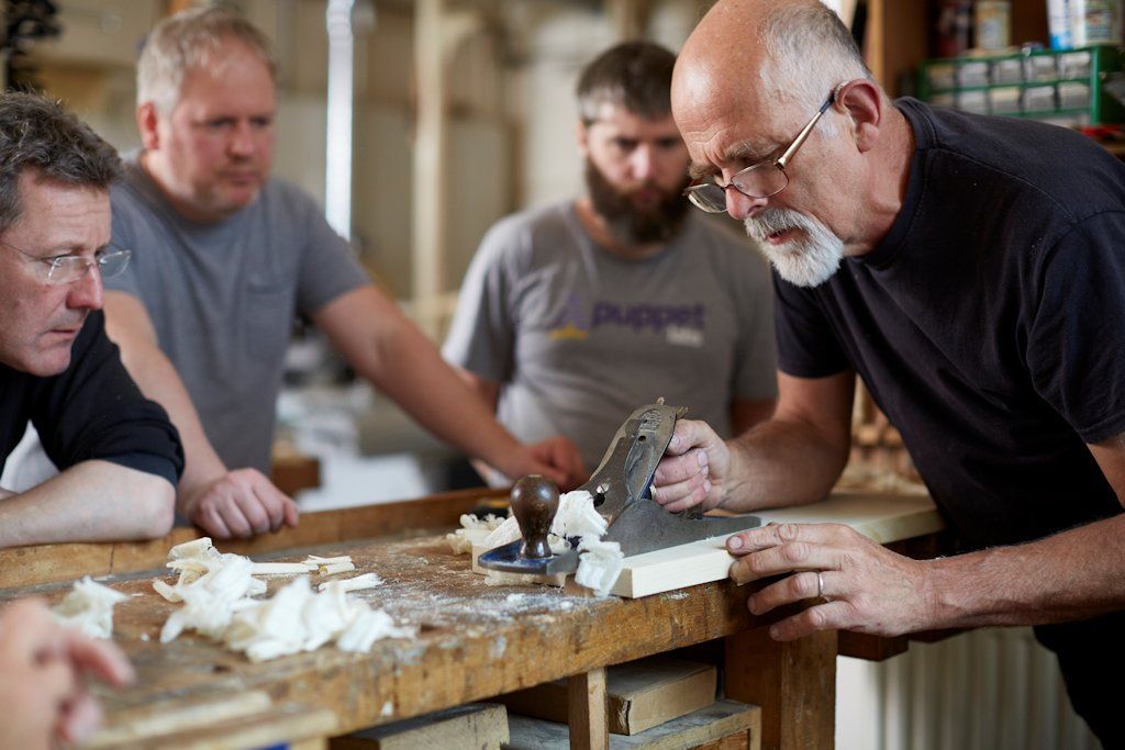 Chris Tribe demonstrating planing techniques to his students