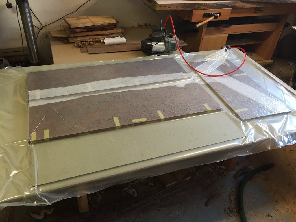 PU glue being used to bond the stone to the MDF in the vacuum bag press
