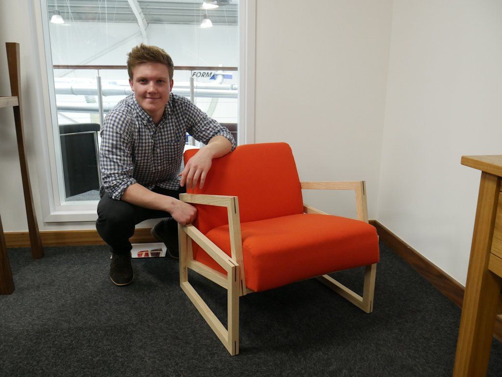 Josh Milton kneels beside his ’Tilt Lounger’