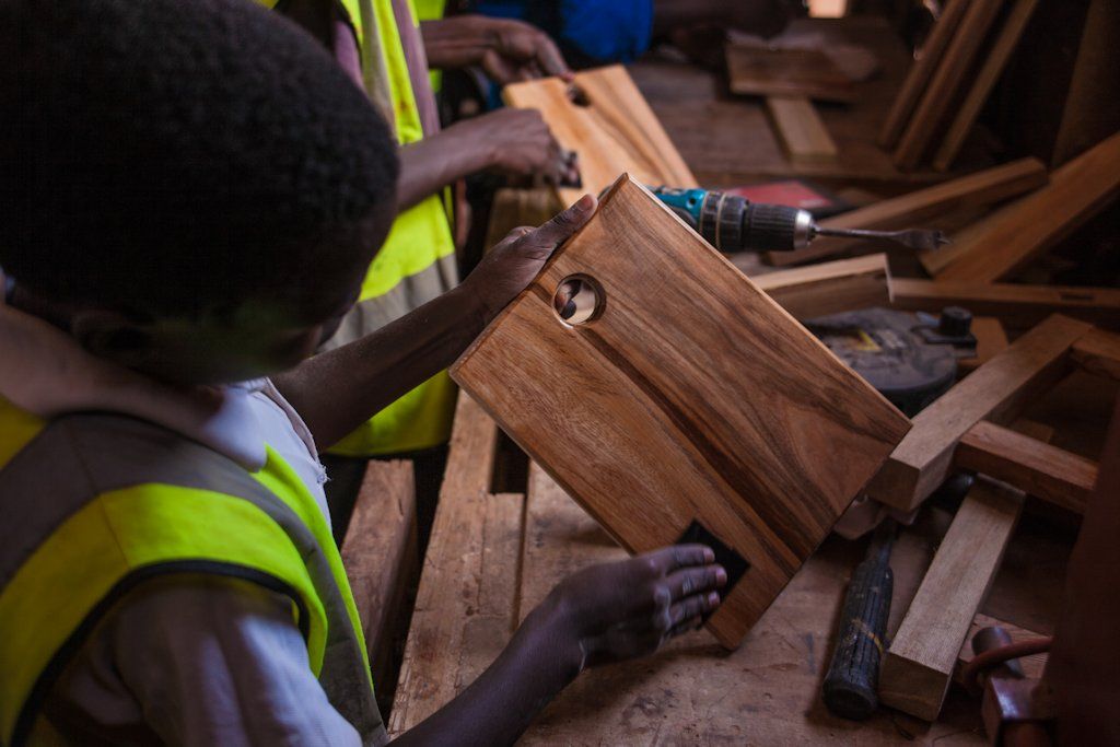 Carpentry project students working on their teak chopping boards