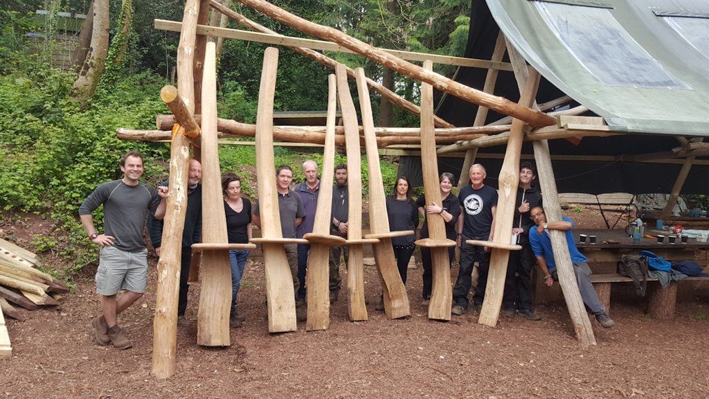 Rick Wheaton plus fellow volunteers and the completed Sharpham Bench