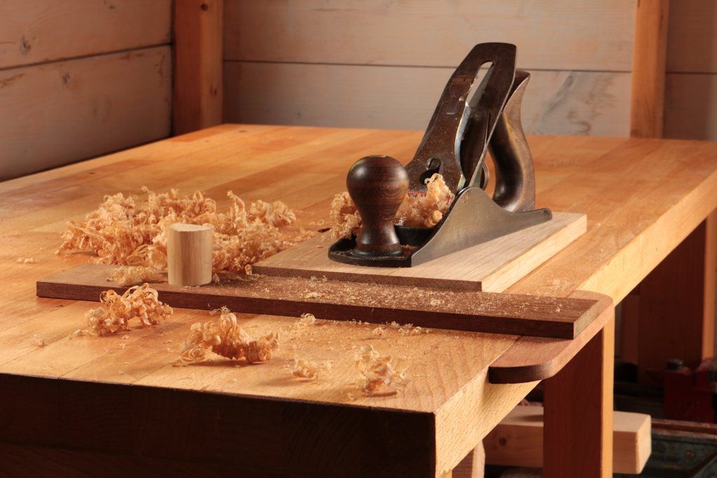 Smoothing an oak board against the 'pegged' planing stop on a flat bench