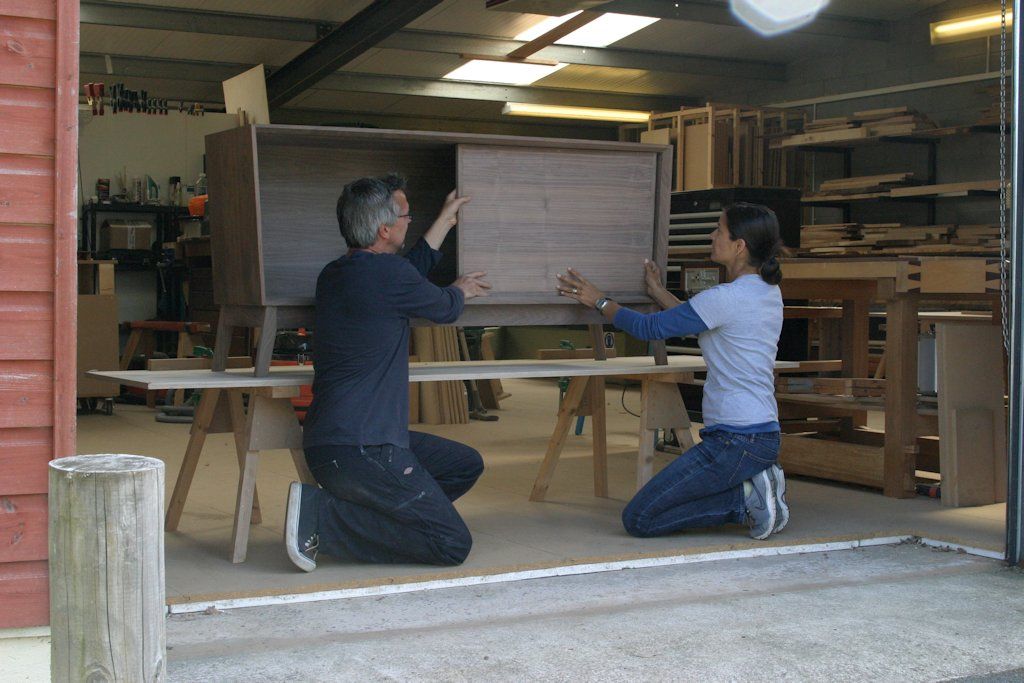 Close to finished, Lakshmi Bhaskaran and Jonathan Walter of Bark Furniture fit the sliding doors at their workshop in North Cornwall