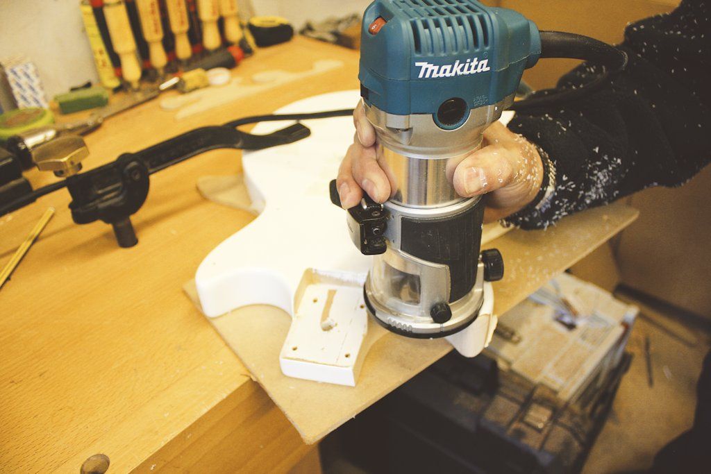 Andy King doing some work on his son’s guitar using a palm router