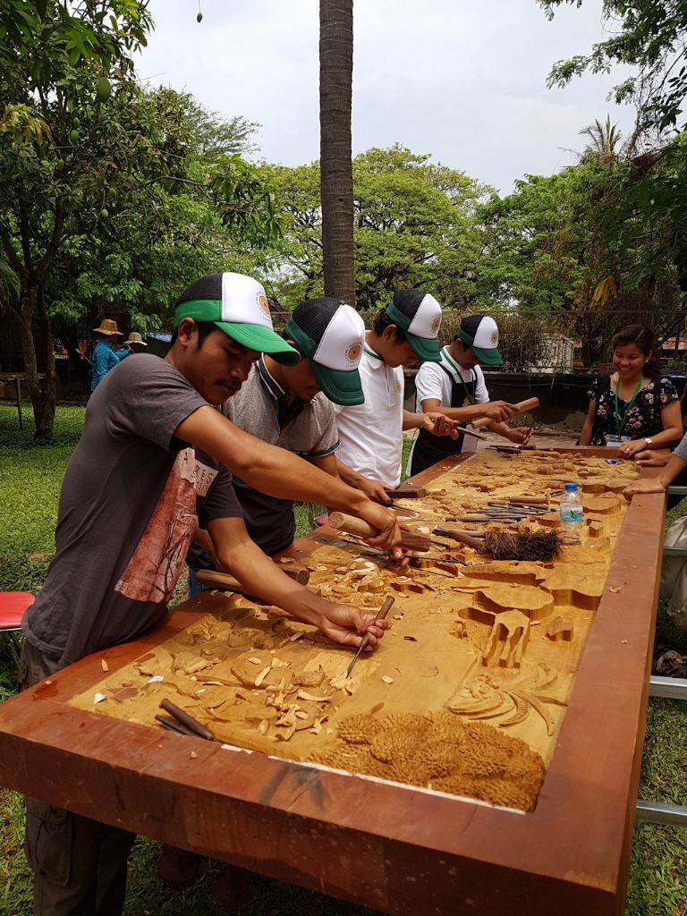Group carving a large panel at the 2018 World Wood Day event in Siam Reap, Cambodia