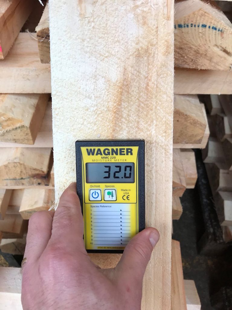 Using a Wagner MMC220 pinless meter to check the moisture levels in a cricket-bat willow cleft