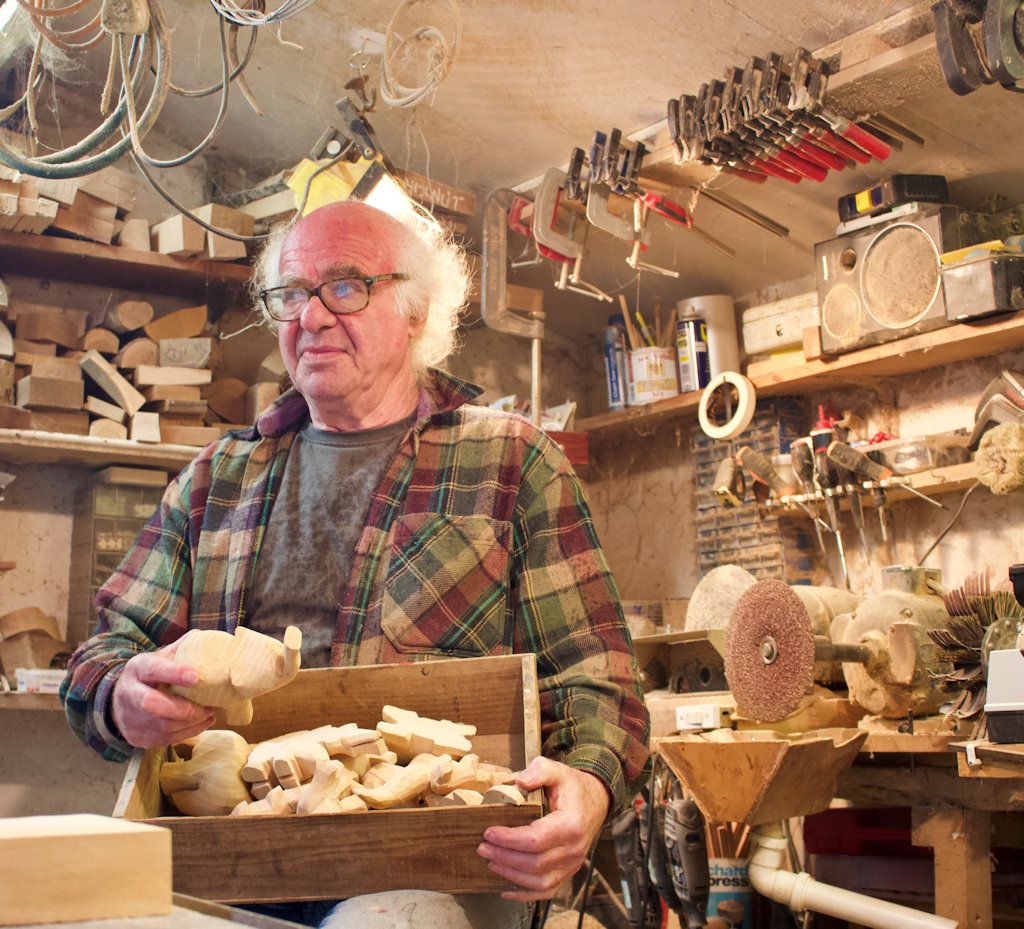 David Plagerson in his Devon workshop with a box of handmade wooden animals